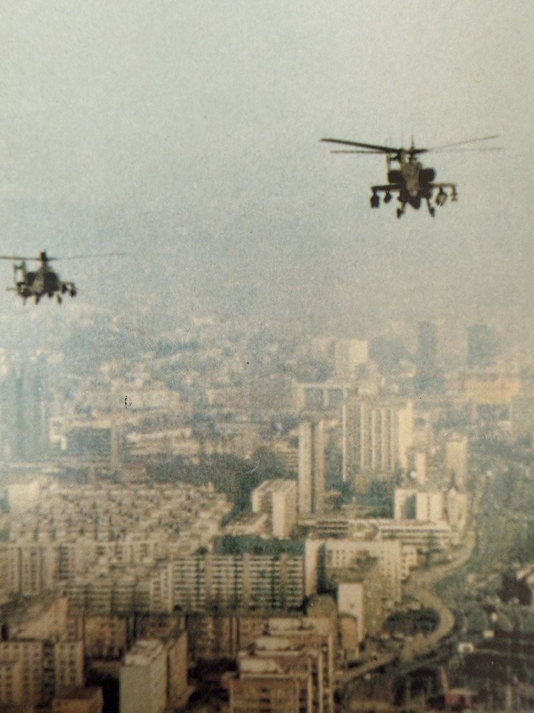 Apache helicopters flying over the hazy city of Sarajevo, Bosnia-Herzegovina, in the 1990s.
